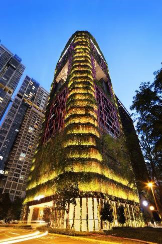 The Oasia Hotel Downtown by WOHA Architects Pte Ltd reinvents the typology of mixed-use towers in the city by introducing creeping plants over the building skin.